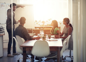 Presentation, businessman and teamwork in office for meeting, project and leadership. Collaboration, brainstorming and group with diversity in conference room for coaching or strategy for company