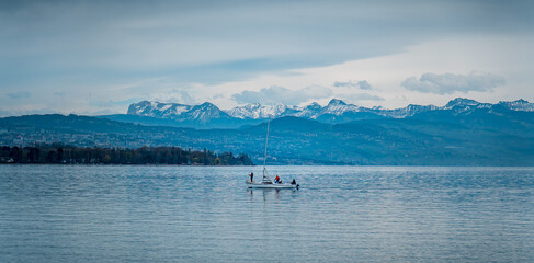 Sailing boat on the lake with a mountainous background