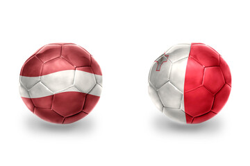 football balls with national flags of malta and latvia , soccer teams. on the white background.