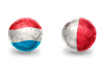 football balls with national flags of malta and luxembourg , soccer teams. on the white background.