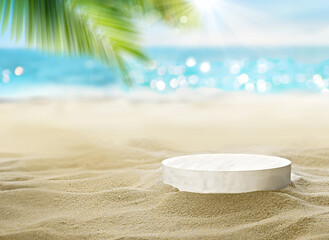 Sunny beach with round pedestal on golden sand under palm tree with ocean in background