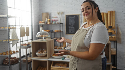 Woman posing in a cozy bakery shop with shelves of bread and pastries in the background