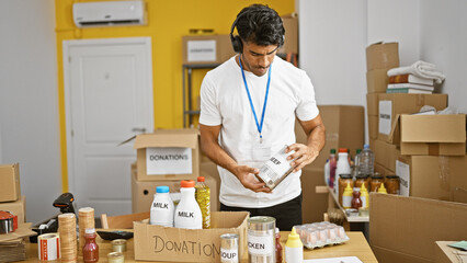 A focused hispanic man organizes canned beef donations in an indoor warehouse setting, exuding a...