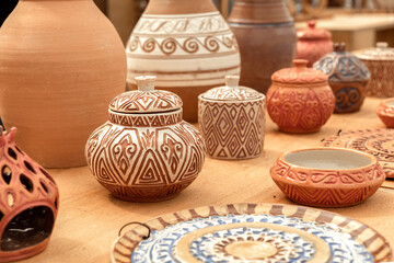 Pottery with traditional Asian designs is sold at a street market. Handmade