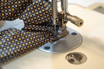 Close up of a woman's hand using a sewing machine