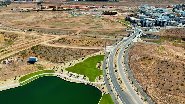 Aerial footage of an artificial lake on Painted Rdg Pkwy near Desert Color neighborhood in Utah, USA