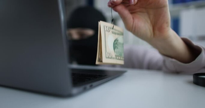 Scammer keeps money on hook and is looking for victim on Internet. Information technology crimes and cybercrime concept