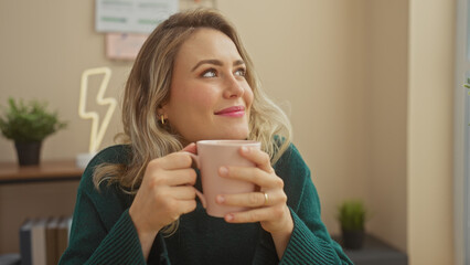 Caucasian woman with blonde hair enjoying coffee at home, looking away in a living room.