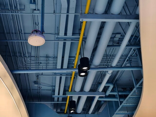 Ceiling with pipes and lights in creates industrial a pattern