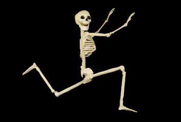 Funny skeleton runs on black background.