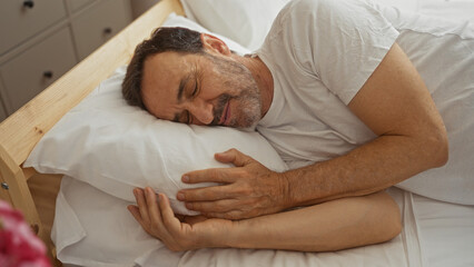 Elderly hispanic man peacefully sleeping in a comfortable bedroom, showing a mature adult male...