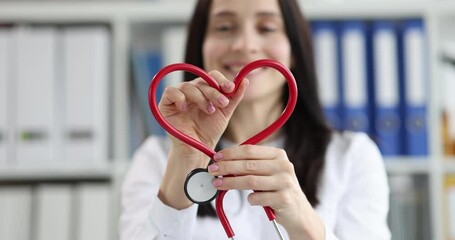 Cardiologist makes heart sign from medical stethoscope. Cardiac disease treatment and donation concept