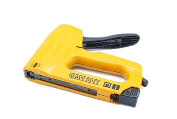 Professional Heavy Duty Stapler or staple gun for Wood, Upholstery, Carpet, Wire Fencing isolated on white background orange yellow color with black rubber grip handle
