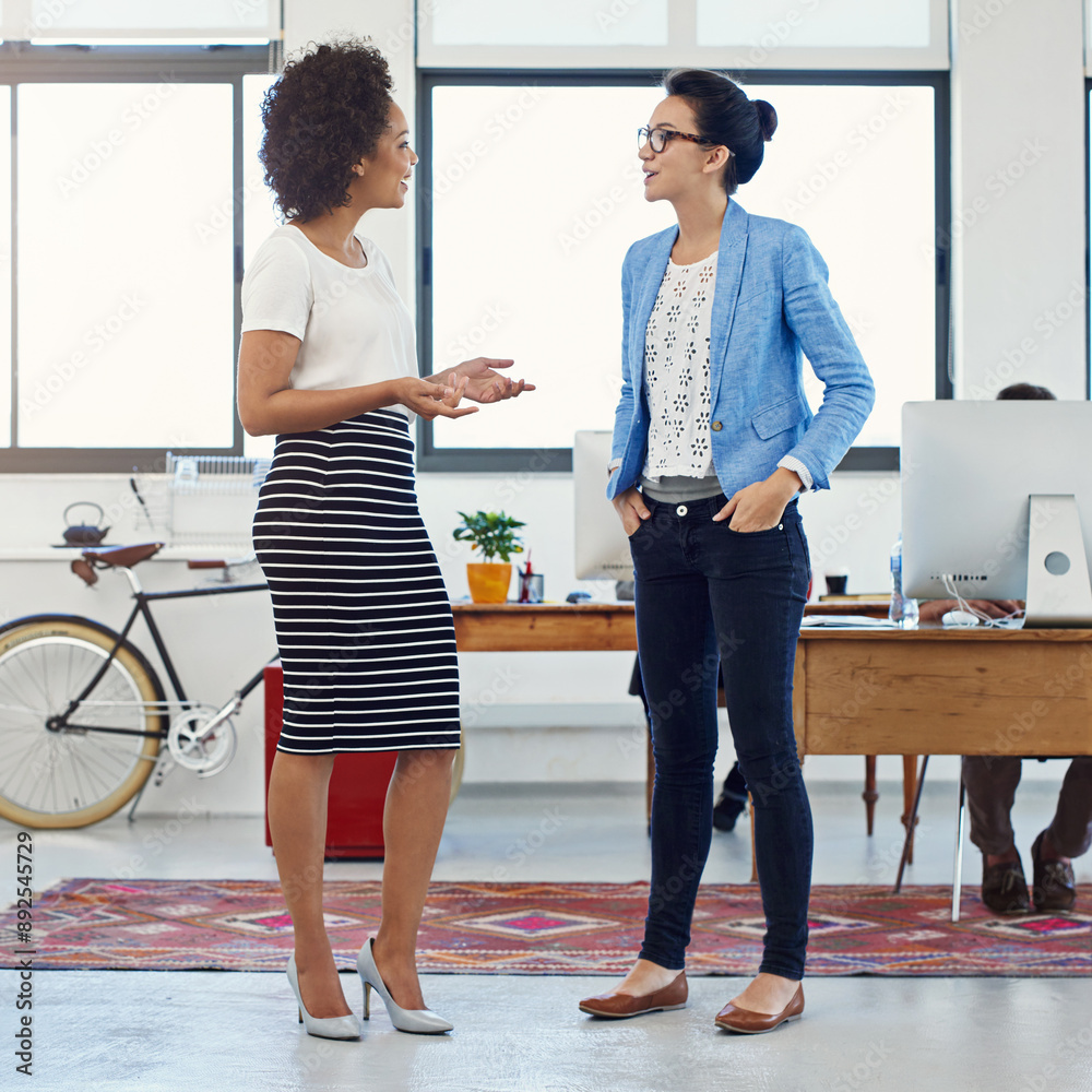 Wall mural Female people, colleague and conversation in office for brainstorming, project or coworking space at job. Women, employee and discussion for communication, teamwork or collaboration in digital agency