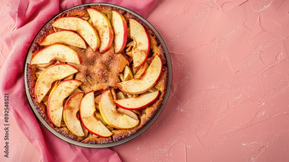 Fototapete rustic spiced apple cake with fresh apple slices on a light red background, cozy and inviting for autumnal text