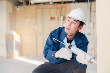 コーキングの施工をする男性の職人