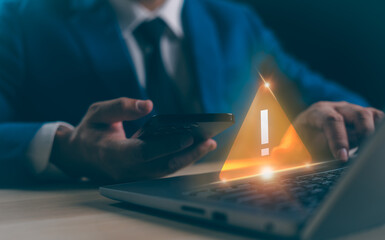 Naklejka premium A Businessman developer working laptop computer with triangle caution warning sign for notification error, maintenance concept, network security, computer virus detected, personal data protection.