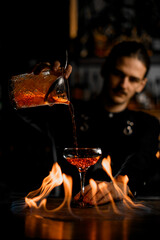 Focused bartender creates a dangerously fiery elixir.