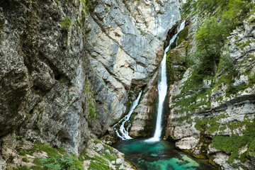 Savica waterfall in a rocky gorge in Slovenia in summer with clean, clear, turquoise water