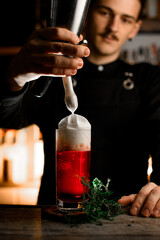 Sweet Surprise. Bartender adds a delightful ending, pouring cream atop cocktail.