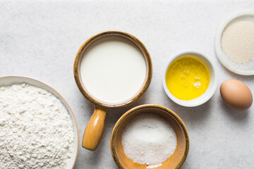 Overhead view of Mise en place of ingredients for making coco bread, ingredients for making jamaican bread on a table, process of making coco bread
