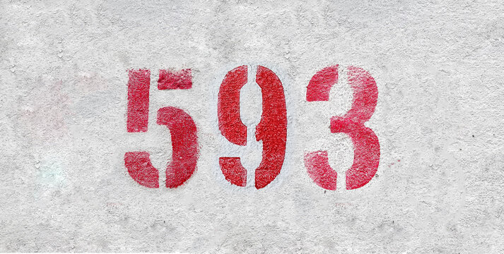 Red Number 593 on the white wall. Spray paint.