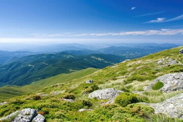 Fototapeta premium Stunning mountain landscape with rolling green hills and a clear blue sky, offering a serene and picturesque view of nature at its finest.