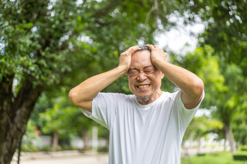 Sick unhappy senior elderly man touching head serious depressed feeling headache thinking of...