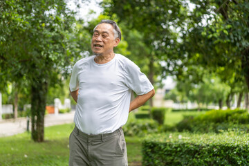 Sick unhappy senior adult elderly man touching her muscle injury Lower back suffering from muscles back pain at home.physical injury and healthcare problem