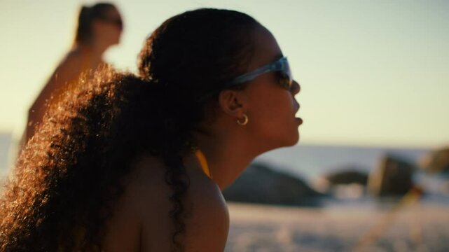 Close-up of skilled beach volleyball teammates at sunset