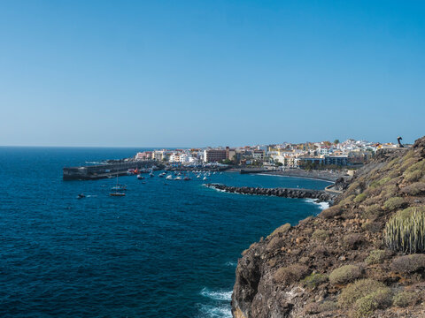 Panoramic view of Playa San Juan town with harbor and protected black sand beach at Guia de Isora. Popular tourist resort at on the south west coast of Tenerife, Canary Islands, Spain.