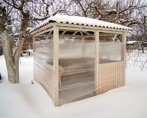 The gazebo at the summer cottage is wrapped with stretch film for the winter