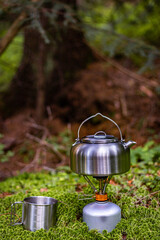 A kettle on the fire during a hike in the mountains.