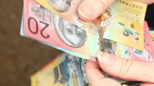Woman counts Australian dollars, close up, Financial concept