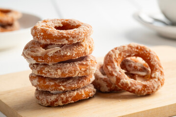 Heap of Sugar coated donuts on wood plate,Ancient Thai Desserts Doughnuts Snack,Sweet food.