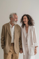 4. Stylish elderly couple holding hands and laughing together, full body, High resolution photography, detailed, realistic, The photo is taken with a Canon EOS R5, with a 17mm, simple solid