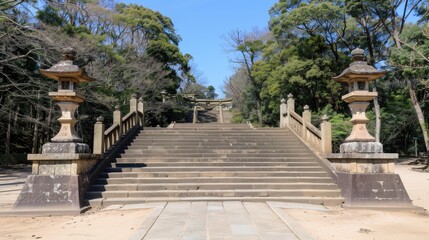 Obraz premium A set of wooden steps leading up a hillside in a Japanese forest. The steps are lined with traditional lanterns with thatched roofs, and the area is covered in fallen leaves