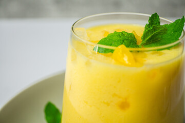 refreshing summer drink decorated with peppermint leaves - mango lassi drink