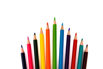 Colored pencils. Colored pencils for drawing are arranged in a row on a white background. A rainbow of pencils