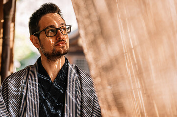 Man in Traditional Yukata with Sunlit Patterns