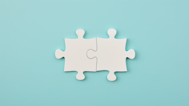 two white puzzle pieces matching together againt light blue background