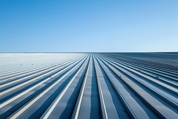 Close-Up of Industrial Building Roof with Light Brown Tiles and White Vertical Stripes Against Blue Sky with Clouds