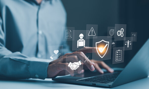 Work safety and compliance concepts. Businessman typing on laptop with virtual icons representing work safety, compliance, and security, workplace safety, and regulatory adherence. Safety first,
