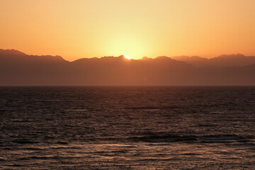 Sunrise view of Gulf of Aqaba of Red Sea and mountains of Saudi Arabia. View from Dahab, Egypt.