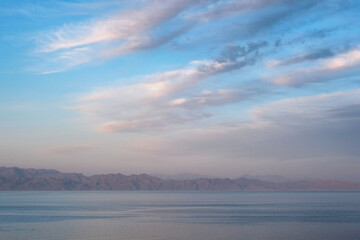 Sunset clouds above Gulf of Aqaba of Red Sea. View from Dahab, Egypt.