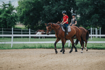 Two young girls riding horses in an outdoor arena, enjoying equestrian sport and leisure activity...