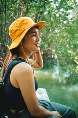 Lovely Happy Asian woman relax in the mangrove forest outdoor activity.