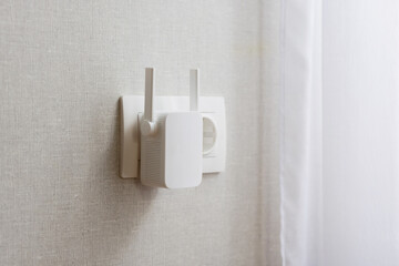 Modern WiFi Range Extender Plugged into Wall Outlet