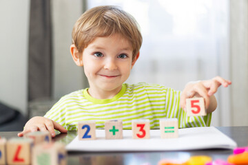 Child Learning Math with Wooden Blocks