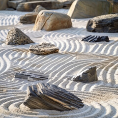 Peaceful zen garden with rocks and sand strategically placed to inspire tranquility and inner peace.